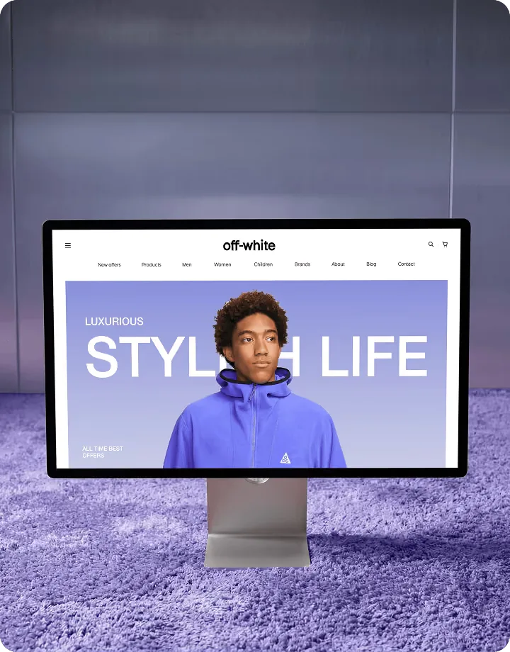 Monitor on a purple carpet showing a fashion storefront